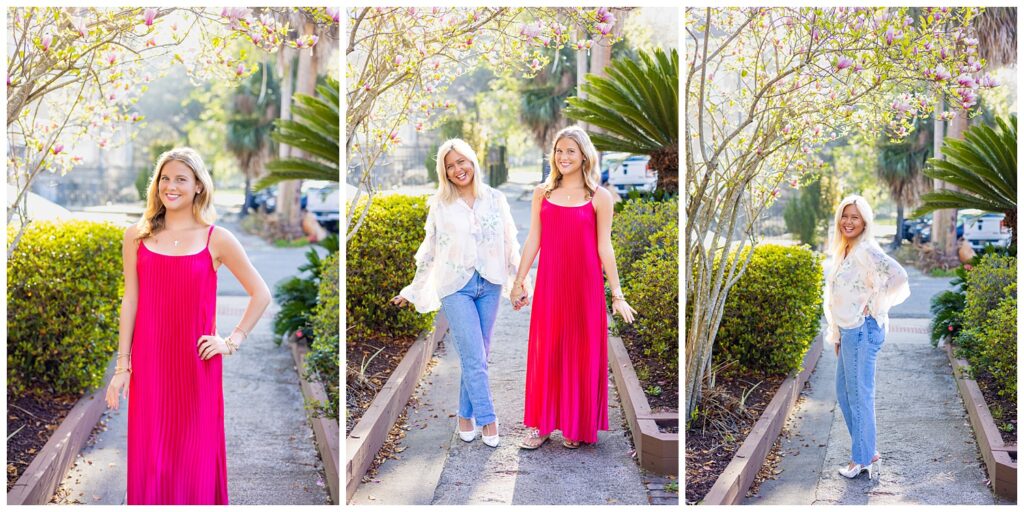 Two high school senior best friends posing and walking together under blooming magnolia trees in downtown Savannah, GA, wearing vibrant pink and soft neutral outfits during a spring senior photo session.